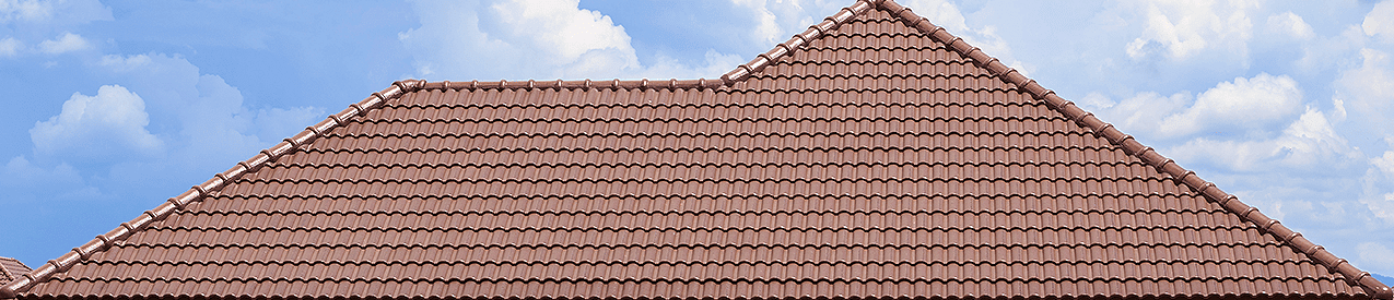 clay tile roof against a blue cloudy sky