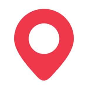 A red location pin icon with a circular cutout in the center, set against a white background.